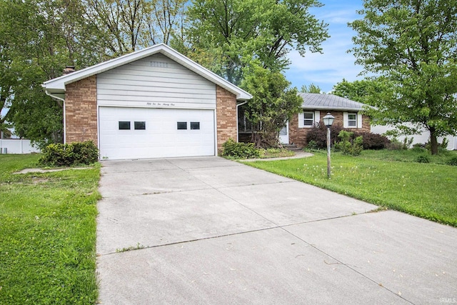 single story home featuring a front yard, brick siding, a garage, and concrete driveway