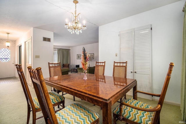 dining space with light colored carpet, a chandelier, and baseboards