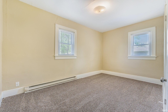 carpeted empty room featuring a baseboard radiator and baseboards