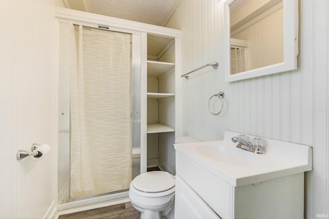 bathroom with vanity, toilet, and wood finished floors