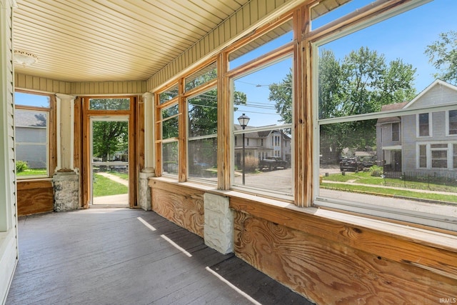 unfurnished sunroom with hardwood / wood-style floors