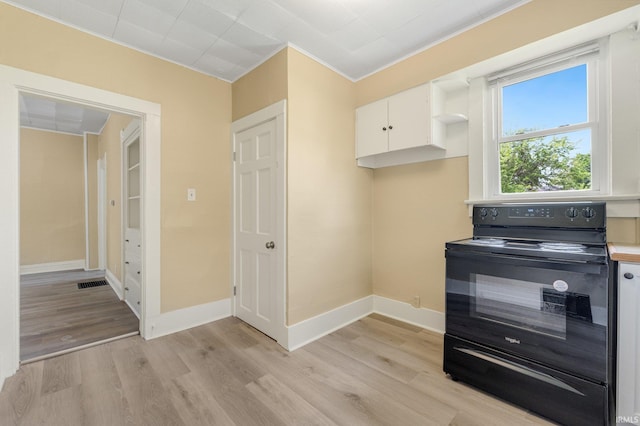 kitchen featuring electric range, light wood-type flooring, white cabinetry, and baseboards
