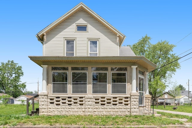 view of front of house with a sunroom