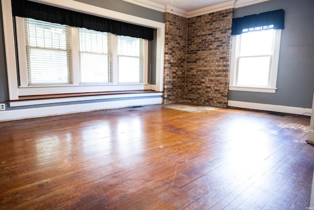 281 Dayton Rd, Dayton, IN 47941 - empty room with ornamental molding, plenty of natural light, hardwood / wood-style flooring, brick wall, and baseboards