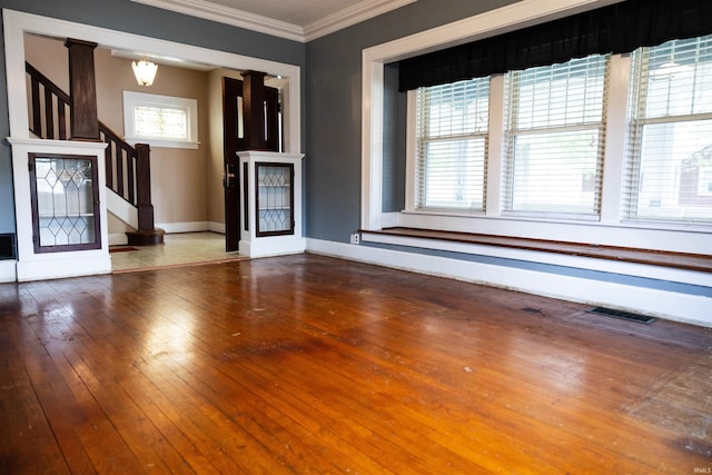 281 Dayton Rd, Dayton, IN 47941 - unfurnished living room featuring stairway, crown molding, hardwood / wood-style flooring, and baseboards