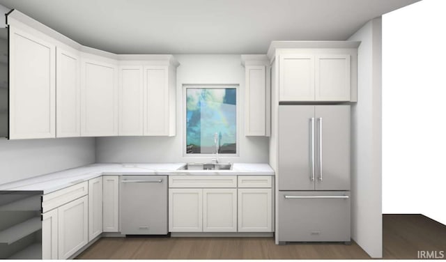 1004 Sorin St, South Bend, IN 46617 - kitchen featuring appliances with stainless steel finishes, wood finished floors, a sink, and white cabinetry