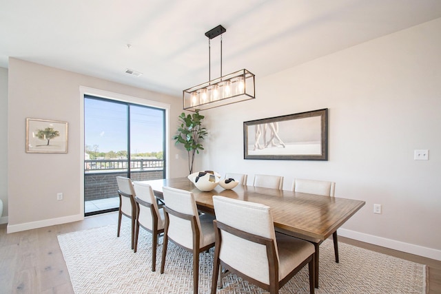 1740301W S Bend Ave, South Bend, IN 46637 - dining area featuring baseboards, wood finished floors, and a chandelier