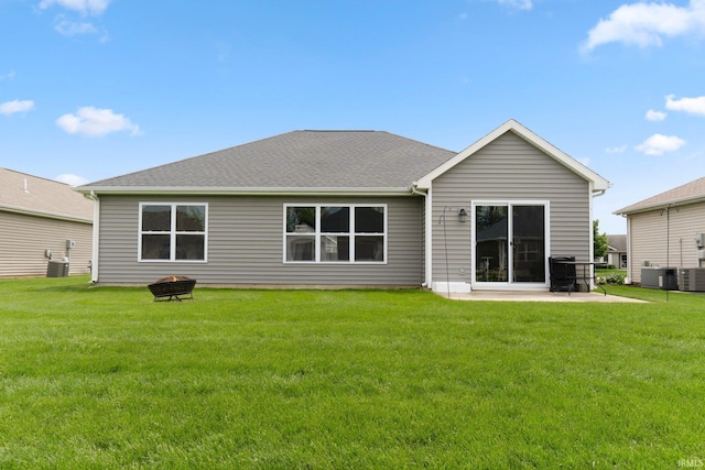 rear view of house with a yard, a patio area, and central AC unit