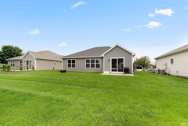 back of property featuring a lawn, a patio, and central air condition unit