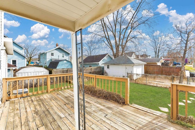 1820 Saint Marys Ave, Fort Wayne, IN 46808 - wooden terrace featuring a residential view, an outbuilding, a detached garage, and a storage unit
