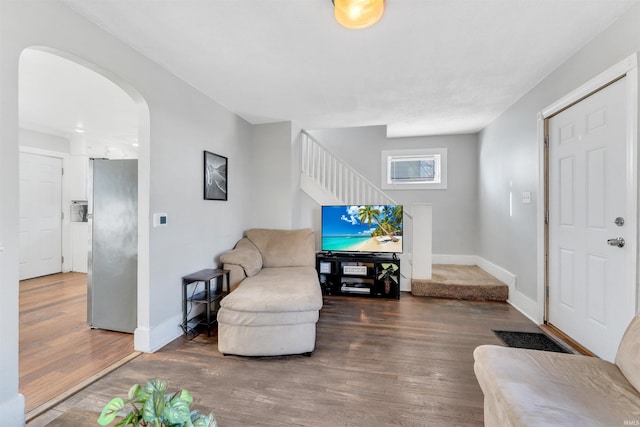 1820 Saint Marys Ave, Fort Wayne, IN 46808 - living room with stairs, wood finished floors, arched walkways, and baseboards