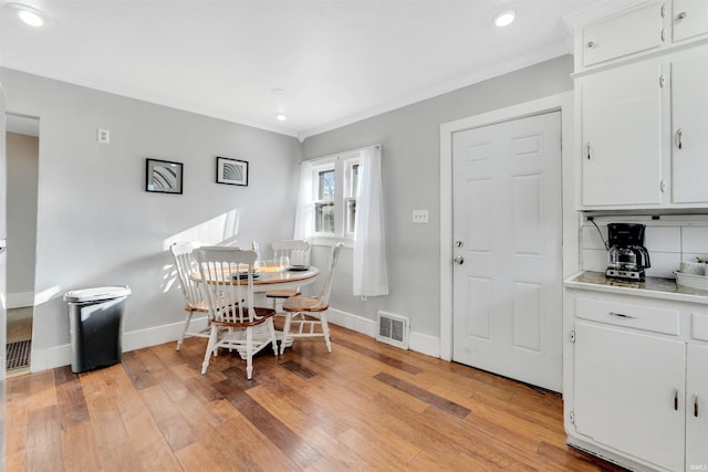 1820 Saint Marys Ave, Fort Wayne, IN 46808 - dining space featuring baseboards, crown molding, light wood-style flooring, and recessed lighting
