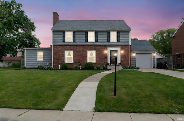 602 Cherokee Ave, Lafayette, IN 47905 - colonial house featuring driveway, an attached garage, brick siding, and a chimney