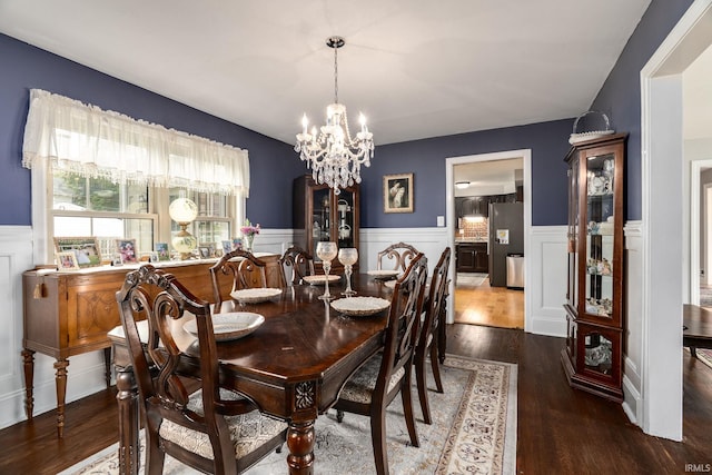 602 Cherokee Ave, Lafayette, IN 47905 - dining room featuring a wainscoted wall, a chandelier, wood finished floors, and a decorative wall