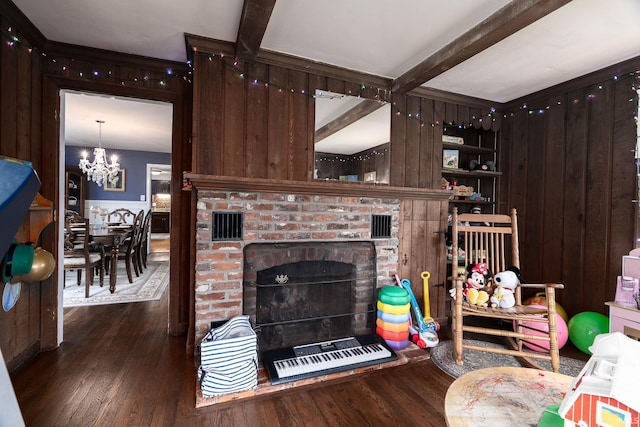 602 Cherokee Ave, Lafayette, IN 47905 - living area featuring wood finished floors, wooden walls, a chandelier, beam ceiling, and a brick fireplace