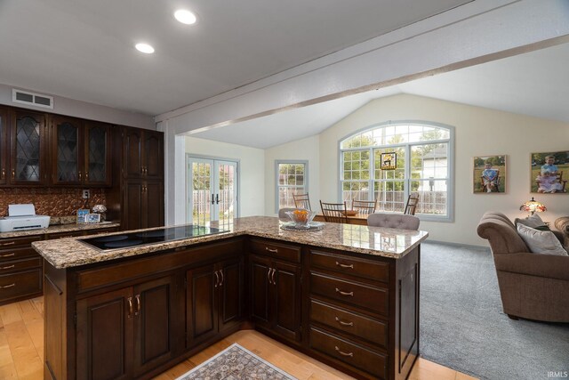 602 Cherokee Ave, Lafayette, IN 47905 - kitchen with black electric cooktop, lofted ceiling, french doors, open floor plan, and light stone counters