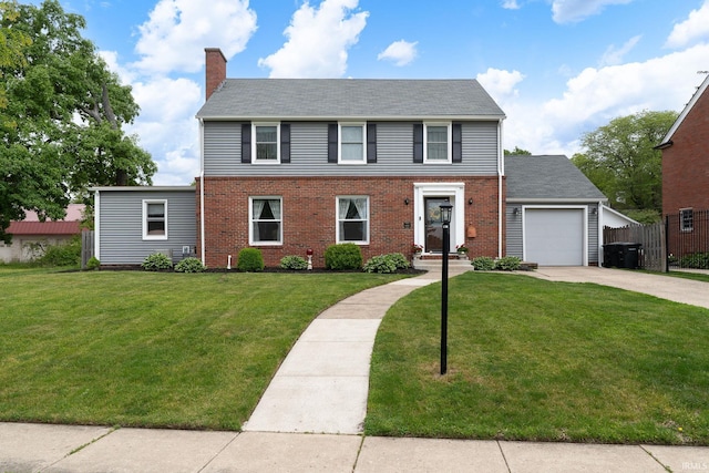 602 Cherokee Ave, Lafayette, IN 47905 - colonial home with driveway, a chimney, a front lawn, brick siding, and a garage