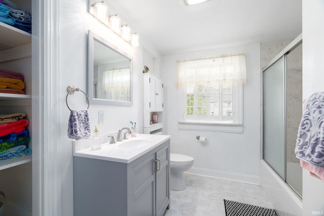602 Cherokee Ave, Lafayette, IN 47905 - bathroom with vanity, toilet, tile patterned floors, and bath / shower combo with glass door