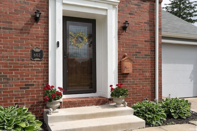 602 Cherokee Ave, Lafayette, IN 47905 - doorway to property featuring a garage, brick siding, and roof with shingles