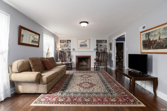 602 Cherokee Ave, Lafayette, IN 47905 - living room featuring baseboards, wood finished floors, a brick fireplace, and built in features