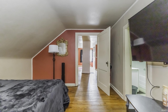 2103 S Hackley St, Muncie, IN 47302 - bedroom featuring light wood-style flooring, vaulted ceiling, and baseboards