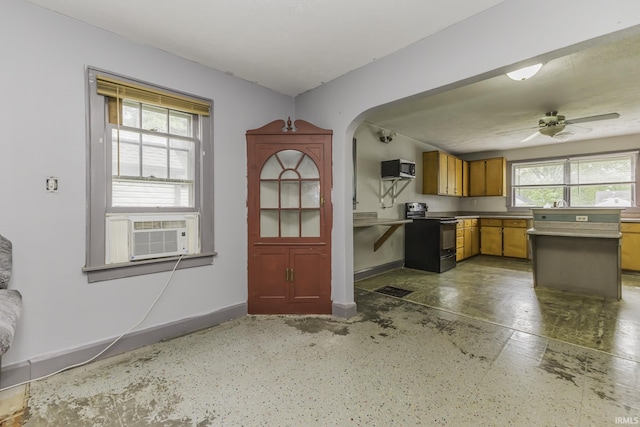 2103 S Hackley St, Muncie, IN 47302 - kitchen with black electric range, cooling unit, brown cabinets, stainless steel microwave, and baseboards