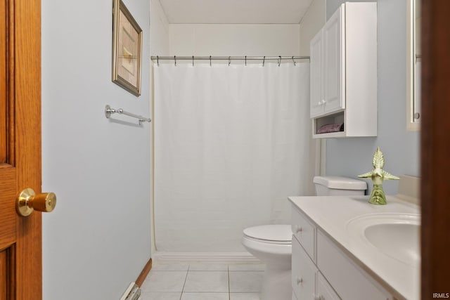 bathroom with toilet, curtained shower, tile patterned floors, and vanity
