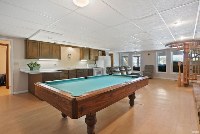 playroom with baseboards, a paneled ceiling, pool table, light wood finished floors, and a sink
