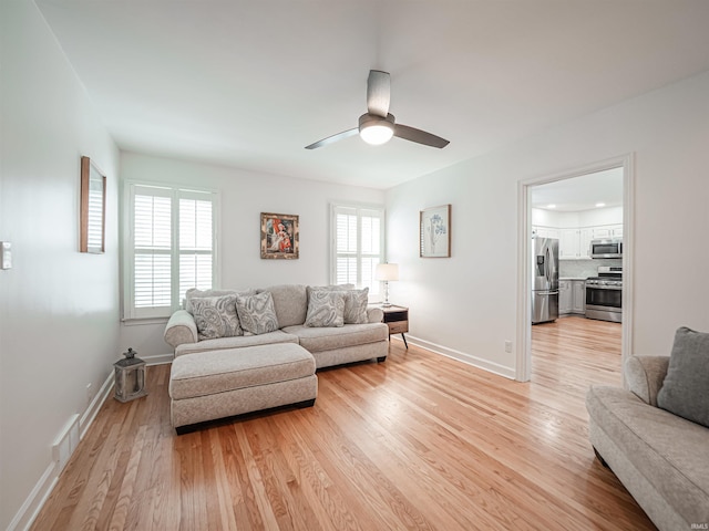 727 Mulberry St, Mount Vernon, IN 47620 - living area with light wood-style floors, a ceiling fan, and baseboards