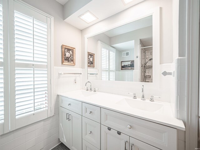 727 Mulberry St, Mount Vernon, IN 47620 - bathroom featuring tile walls, double vanity, a wainscoted wall, and a tile shower