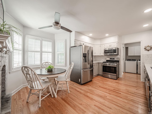727 Mulberry St, Mount Vernon, IN 47620 - kitchen featuring appliances with stainless steel finishes, washing machine and clothes dryer, plenty of natural light, decorative backsplash, and recessed lighting