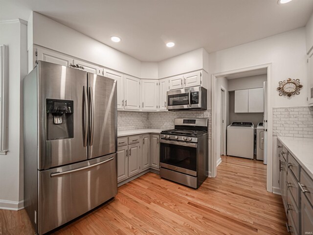 727 Mulberry St, Mount Vernon, IN 47620 - kitchen featuring appliances with stainless steel finishes, washing machine and dryer, gray cabinetry, tasteful backsplash, and recessed lighting