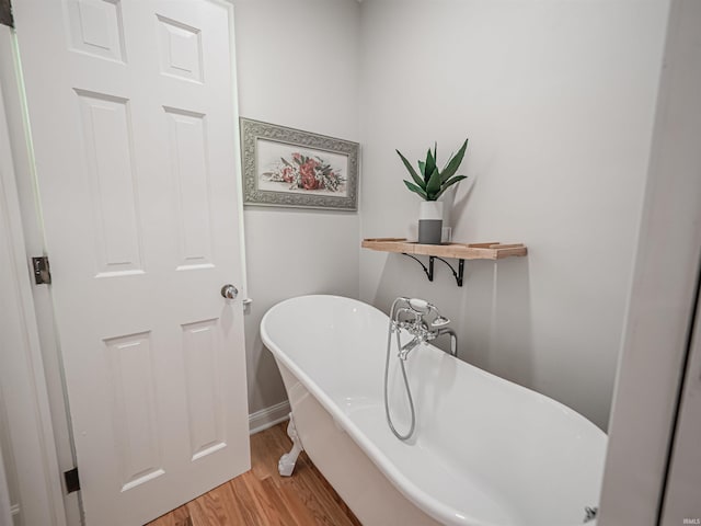 727 Mulberry St, Mount Vernon, IN 47620 - full bathroom with wood finished floors, a soaking tub, and baseboards