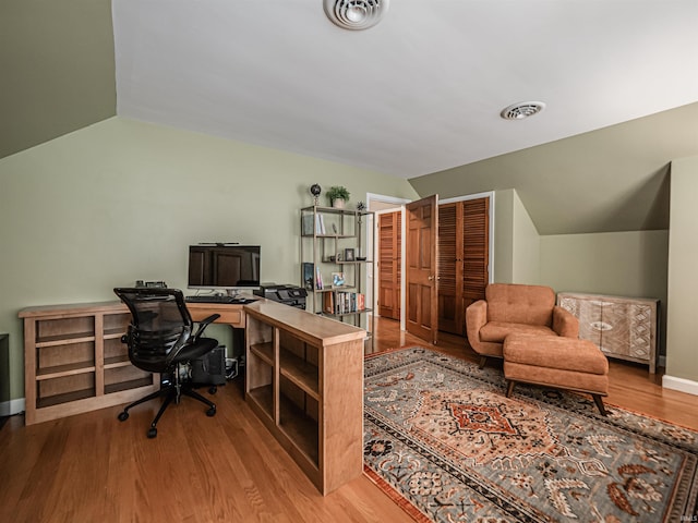 727 Mulberry St, Mount Vernon, IN 47620 - home office featuring vaulted ceiling, wood finished floors, and baseboards