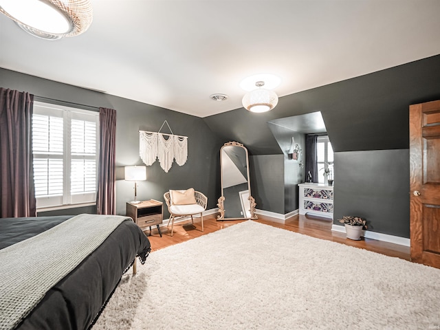 727 Mulberry St, Mount Vernon, IN 47620 - bedroom with multiple windows, baseboards, wood finished floors, and vaulted ceiling