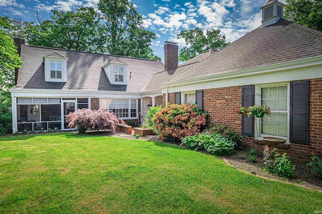 727 Mulberry St, Mount Vernon, IN 47620 - view of front of property featuring brick siding, a front lawn, a chimney, a sunroom, and roof with shingles