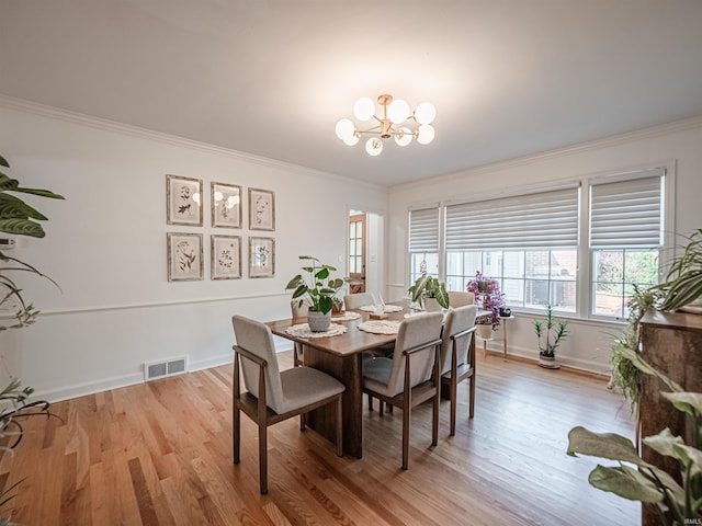 727 Mulberry St, Mount Vernon, IN 47620 - dining room featuring a chandelier, crown molding, light wood-type flooring, and plenty of natural light