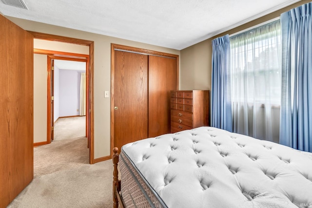 1723 Central St, Lafayette, IN 47905 - bedroom with light colored carpet, a closet, and baseboards