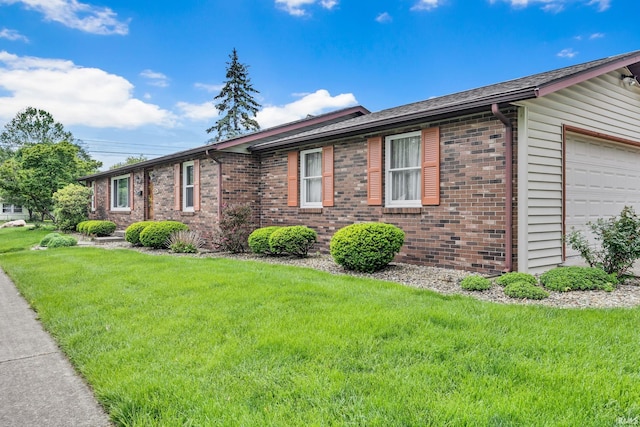 1723 Central St, Lafayette, IN 47905 - view of front of property featuring a garage, brick siding, and a front yard