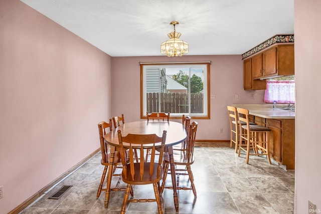 1723 Central St, Lafayette, IN 47905 - dining space with a chandelier and baseboards