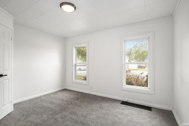 unfurnished room featuring carpet floors, crown molding, and baseboards