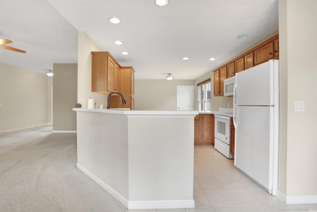 5849 Porterfield Dr, Evansville, IN 47711 - kitchen featuring white appliances, a peninsula, recessed lighting, baseboards, and light countertops