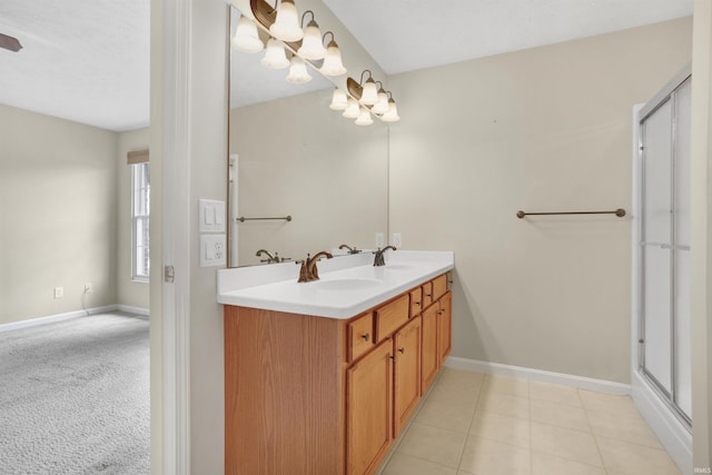 5849 Porterfield Dr, Evansville, IN 47711 - bathroom featuring double vanity, a shower stall, and baseboards