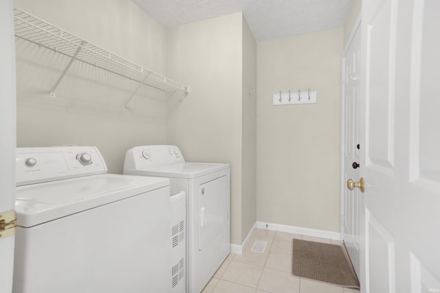 5849 Porterfield Dr, Evansville, IN 47711 - laundry area featuring independent washer and dryer, light tile patterned flooring, and baseboards