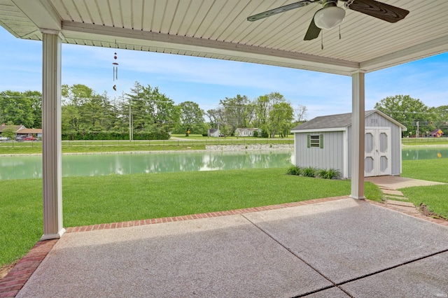 5849 Porterfield Dr, Evansville, IN 47711 - view of patio / terrace with a ceiling fan, a water view, a storage unit, and an outbuilding