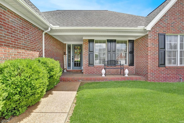 5849 Porterfield Dr, Evansville, IN 47711 - property entrance with a porch, brick siding, roof with shingles, and a lawn