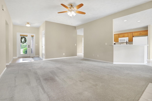 5849 Porterfield Dr, Evansville, IN 47711 - unfurnished living room featuring ceiling fan, baseboards, and light carpet