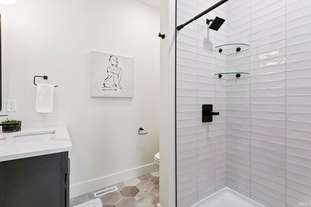 732 S Bend Ave, South Bend, IN 46617 - bathroom with a stall shower, baseboards, toilet, and vanity