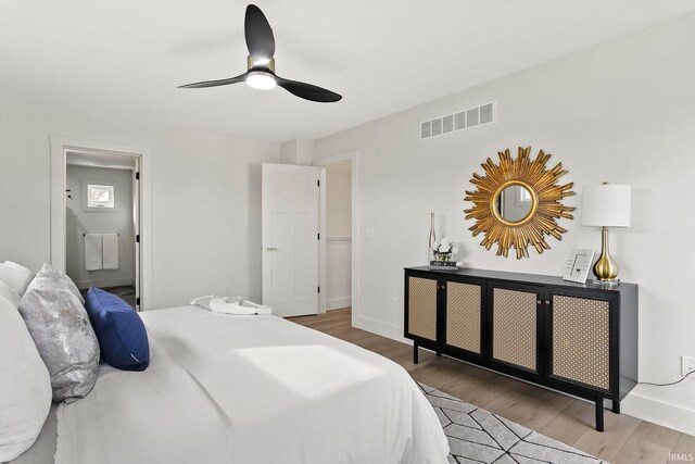 732 S Bend Ave, South Bend, IN 46617 - bedroom featuring wood finished floors, baseboards, ensuite bath, and ceiling fan
