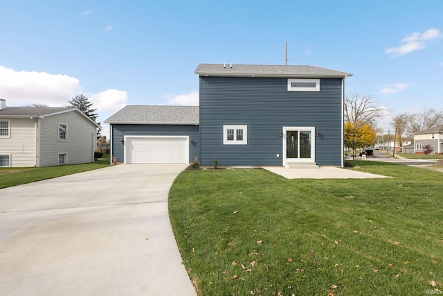 732 S Bend Ave, South Bend, IN 46617 - back of house featuring concrete driveway, an attached garage, and a yard
